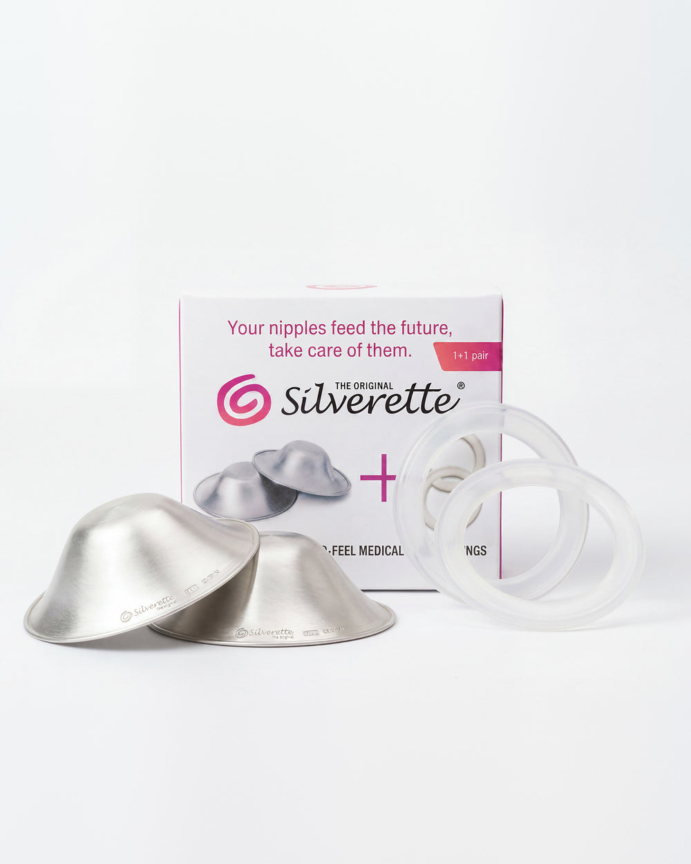 Pair of Silverette 925 sterling silver nursing cups and two clear O-Feel silicone rings in front of the Silverette cups + O-Feel box