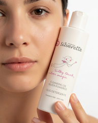 Woman holding Silverette Cleansing Oil to her face, a gentle facial cleanser for sensitive skin
