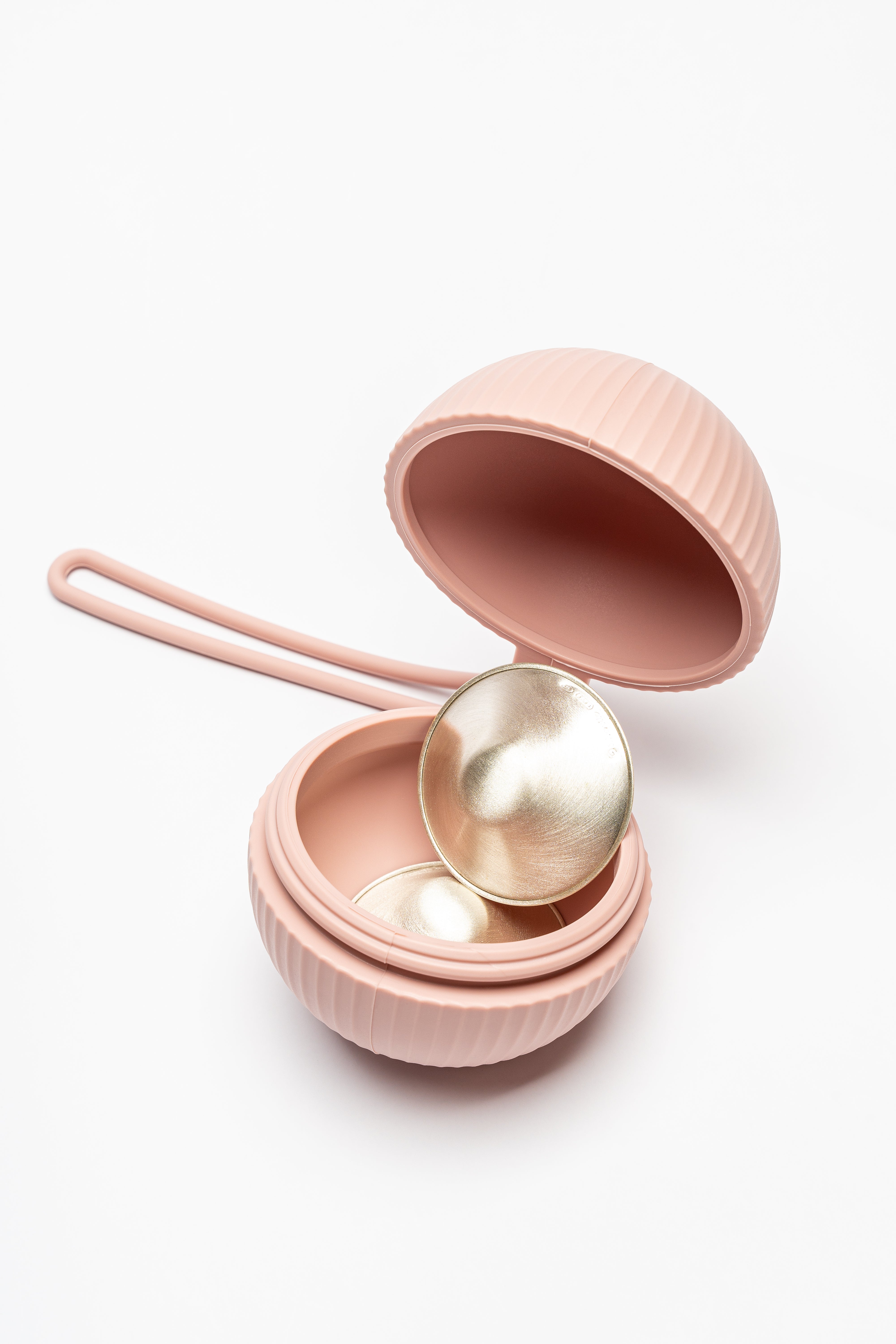 Open silicone cup holder with a Silverette silver nursing cup stored inside