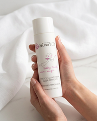 Hands holding a bottle of Silverette Stretch Marks Cream 200ml